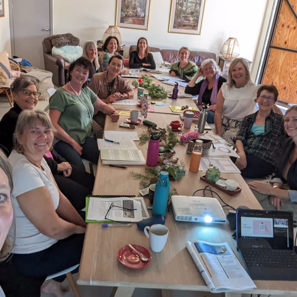 Group of women entrepreneurs at a business workshop led by Selena Woodward, highlighting collaboration and community in the Biz Sisters network.