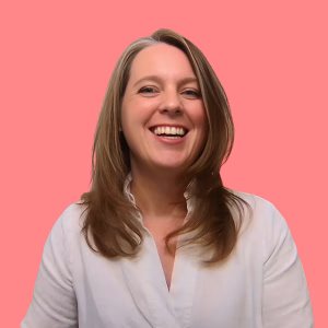 Selena Woodward smiling against a coral background